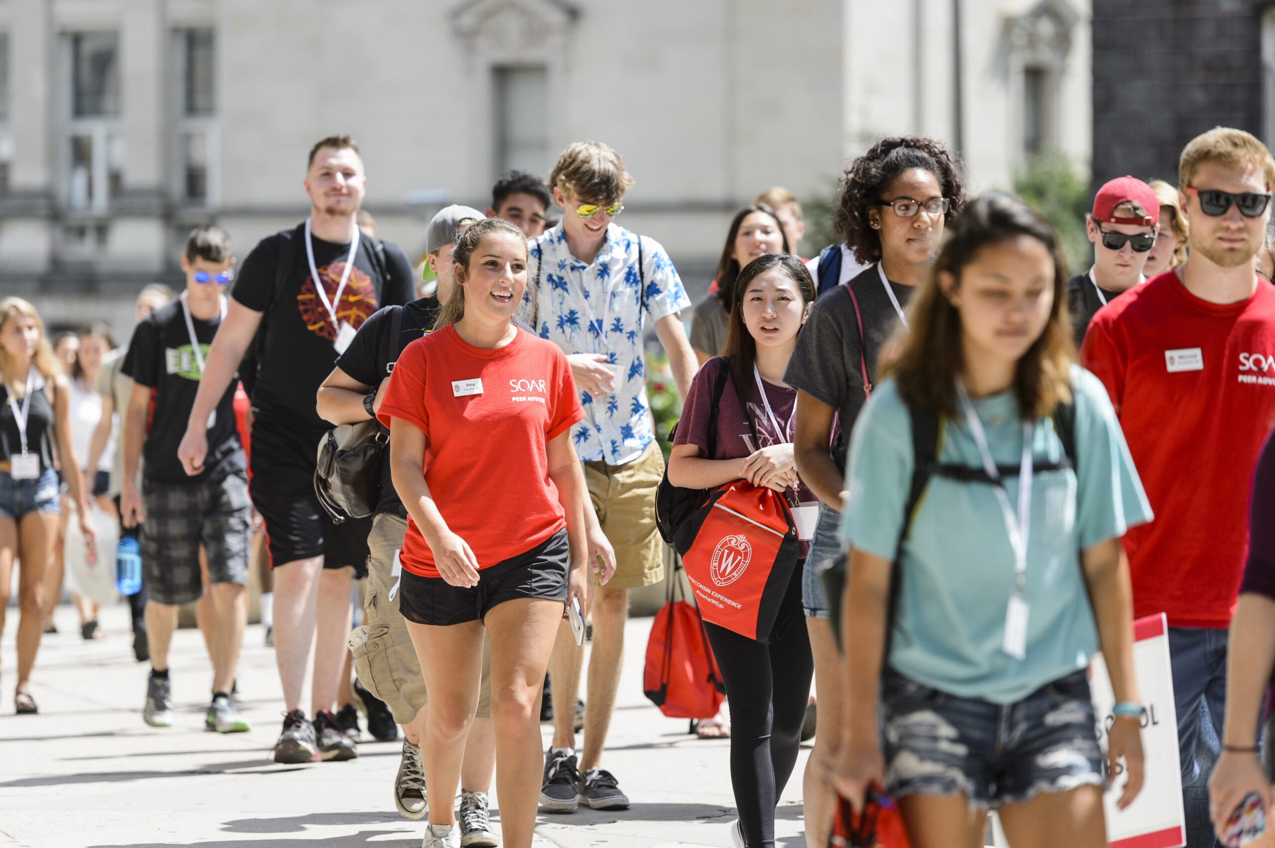 Student leaders walk with incoming undergraduates to a SOAR session