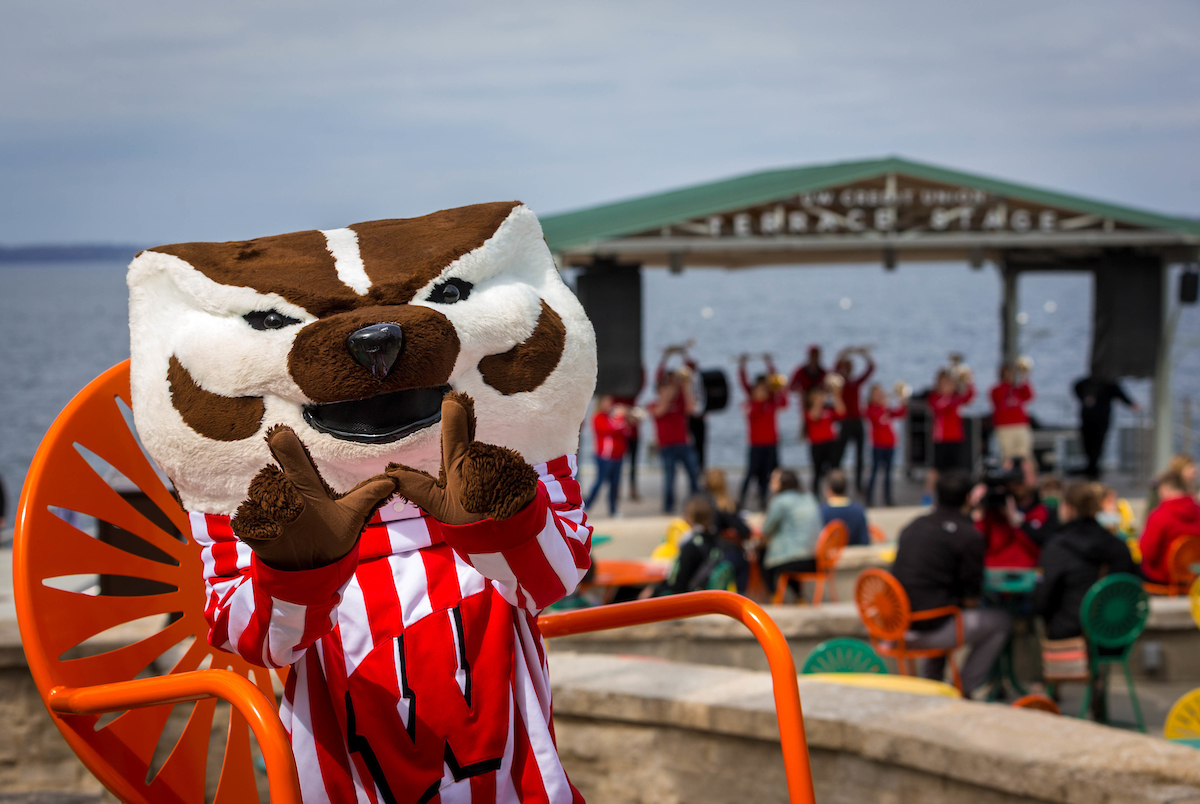 Bucky Badger poses for a photo in front of the Terrace Stage